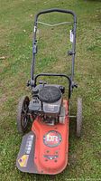 Front view of walk-behind string trimmer showing deck, engine, and handle