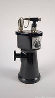 Side view of the black metal torch showing shape and cap with ball chain.