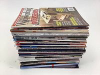 Stack of over 50 woodworking magazines, showing thickness and spine edges