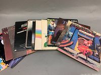 Full lot of 15 vinyl records arranged in a fan showing album covers.