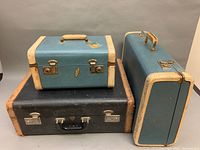 Side and top view of the three-piece luggage set showing the different sizes and colors.