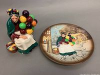 Porcelain figurine and collectors plate shown side by side, showing overall design and size relation.