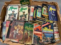 Photo showing assorted paperback books from The Avengers and Blade series in a box with visible wear.