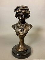 Front view of vintage female bust sculpture showing detailed bronze finish and facial features.
