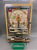 Full front view of machine showing cabinet, playfield and tray of balls