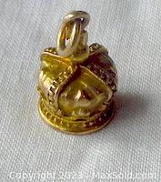 Close-up front angle of yellow gold crown charm showing detailed embossed design and bail loop