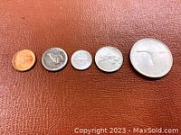 Reverse side of five 1967 Canadian coins featuring various wildlife designs