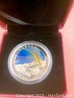 Photo of the coin inside its original black display case showing the colored rainbow design and inscriptions "CANADA 20 DOLLARS 2016".