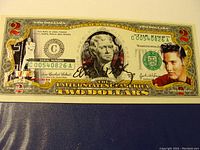 Front of a two dollar bill with colorized red and gold numeral 2 on left, portrait of Thomas Jefferson in center, and large colorized image of Elvis Presley on the right. Serial number C00540826A is shown.