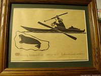 Full view of framed lithograph showing Eskimo hunting walrus in kayak