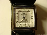 Front view showing silver dial, applied numerals and indices, date at 3