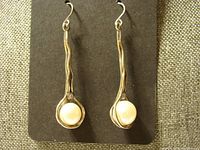 Front view of silver dangle earrings showing pearl and rhinestone details.