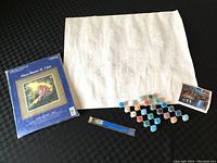 Acrylic paint by number kit includes white canvas with numbers, paint pots, and brushes