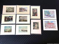 Full view of all ten prints arranged on a flat surface, showing variety of themes including maritime, portrait, and landscape prints.