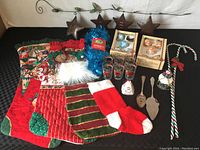 Full lot contents showing Metal NOEL sign, stockings, glasses, ornaments, garland, candy dish, and utensils.