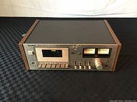 Front view of Sony TC-186SD stereo cassette deck showing buttons, cassette slot, and VU meters.