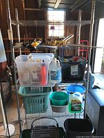 Full view of shelving unit loaded with various containers and cleaning supplies to show scale and structure.