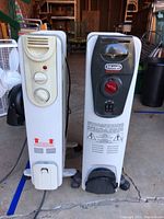 Front view of both space heaters side by side showing control panels.