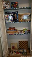 Overall view of shelf with boxed kits, games and board on floor