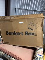 Front side of a large cardboard Bankers Box with branding and storage unit illustration