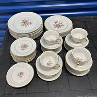 Full set arranged showing all plates and cups with saucers.