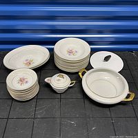 Full set arranged showing all bowls, creamer, and casserole dish with lid.
