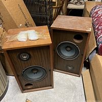 Full view of two wood veneer Marantz Imperial 6G speakers showing front drivers and wear on top surfaces.