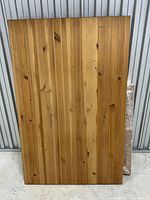 Top-down view of the natural wood table top with visible wood grain and knots