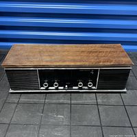 Front top-down view of the Panasonic AM-FM radio showing the wood finish and speaker grill