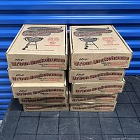 Ten stacked boxes of Urban Smokehouse labeled smoking wood chips in cardboard boxes.