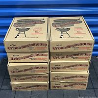 Ten sealed cardboard boxes of Urban Smokehouse mini smokers stacked in two columns of five each.