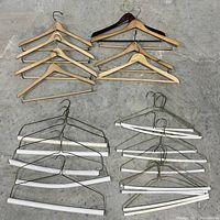 Top-down view showing all hangers in the lot arranged on the floor against concrete background.