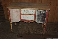 Front view of rustic buffet showing two drawers and two cabinet doors with distressed paint.
