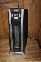 Front view of the Delonghi Safe Heat electric heater showing its mesh front panel and brand name on the base.