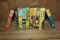 Books standing upright showing spines and titles for identification of collection contents.
