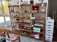 Full front view of bookcase loaded with items