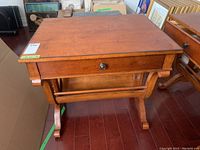 Front view showing top surface, drawer with knob, and front curved legs.