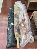 Four fabric rolls laid side by side on wooden floor