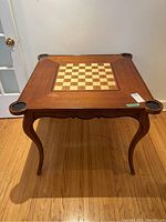Full view of square wood games table showing veneer finish, inlaid chessboard centre and cup holder corners