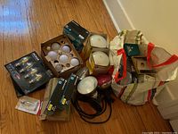 Full lot including boxes and bags of household light bulbs, some new, various brands visible