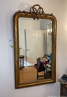 Full front view of rectangular gold painted wall mirror.