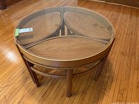 Assembled nested tables, round table on top with three smaller tables beneath