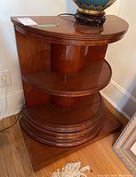 Front-left angle showing three tiers and rectangular base