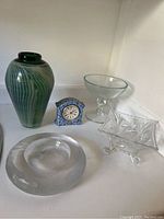 Lot showing all items: green art glass vase, ceramic clock, clear glass compote bowl, leaded glass bowl, and frosted ashtray or candy dish