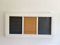 Front view showing the entire rectangular frame with two chalkboards and corkboard center panel.