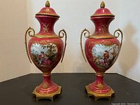 Pair of urns, full front view showing shape, color and handles