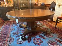 Full view of round table top and carved apron