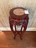 Full view of carved rosewood pedestal table with round marble top
