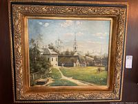 Full frontal view of framed painting hung on wall