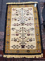 Full view of rectangular rug showing entire tree pattern and border